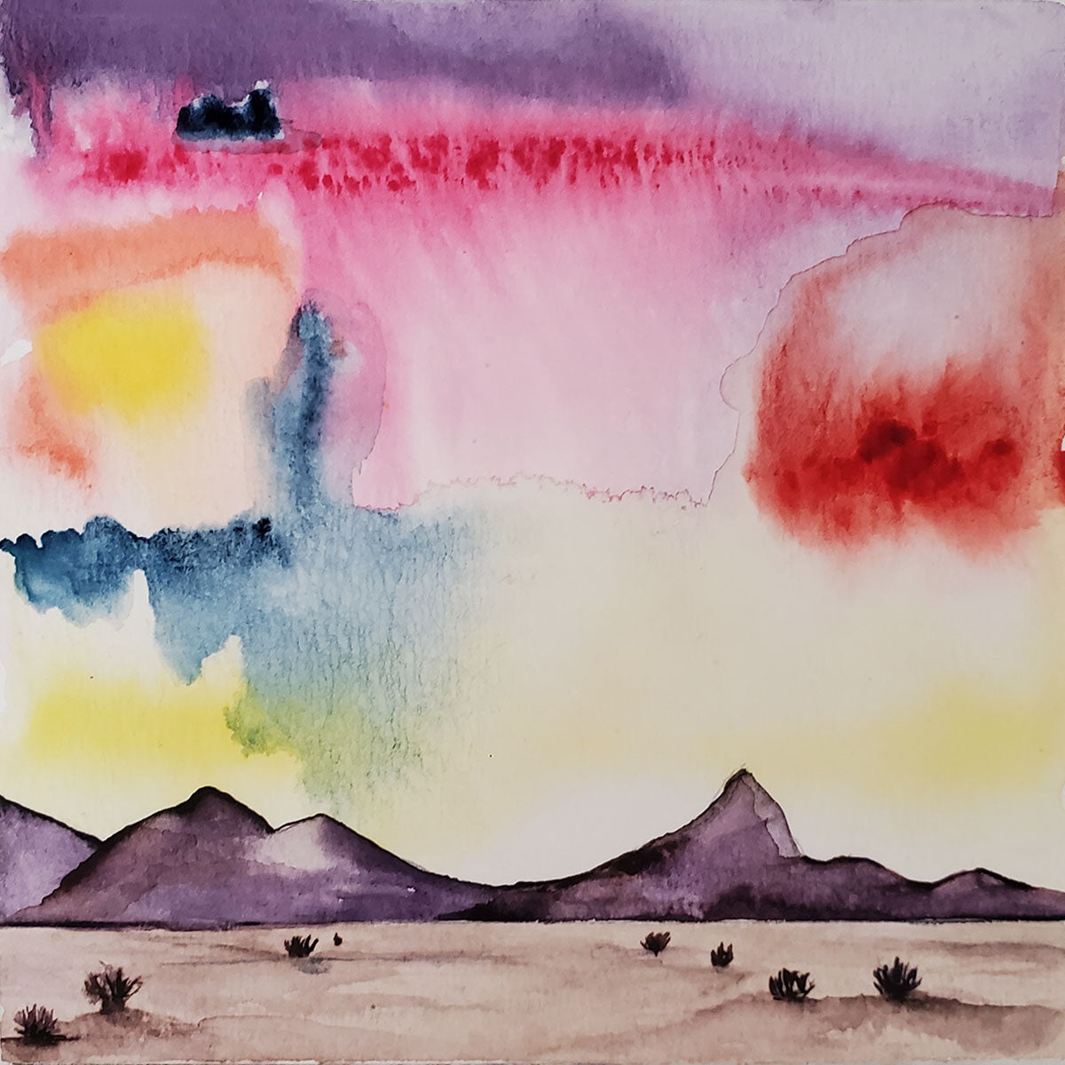 Painting the Sonoran desert with tumbleweeds and monsoon skies. Small watercolor, 5x5 inches, bright monsoon sunset sky, low mountain range and a few tumbleweeds. Ready to hang. 